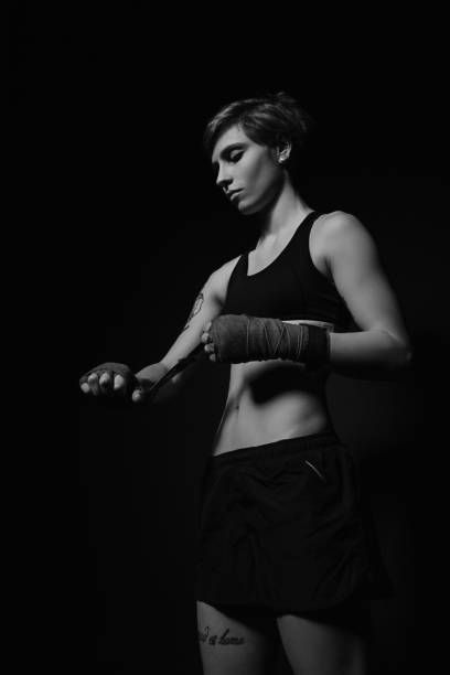 istock Woman wrapping hands with boxing wraps 657613296