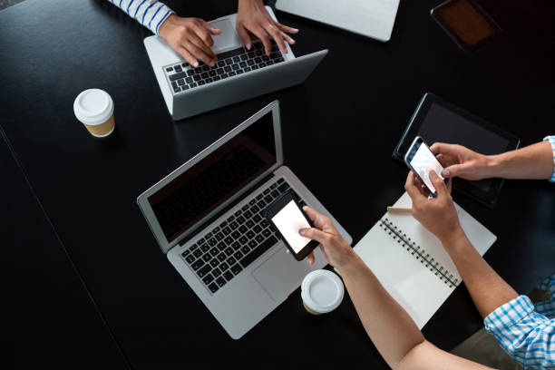 istock Man and women using mobile phone and laptop 657616676