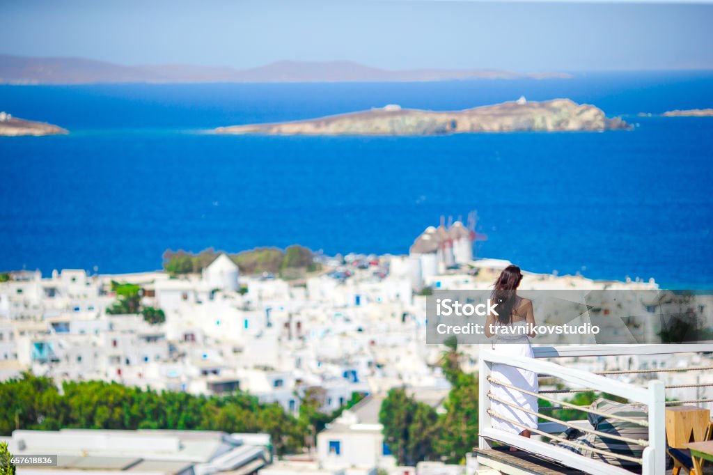 Happy tourist woman enjoy amazing view on Mykonos, Greece Beautiful woman enjoying summer vacation near pool Adult Stock Photo