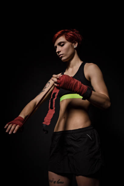 istock Woman is wrapping hands with red boxing wraps 657619196