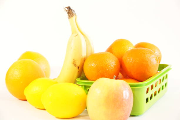 Ripe fruit isolated on white background. Bananas, tangerines, oranges, lemon, kiwi, apple on the table