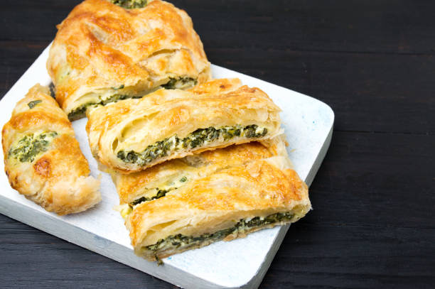 istock Spinach and cheese pie slices on a tray 657619710