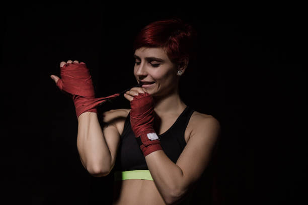 istock Woman is wrapping hands with red boxing wraps 657626698