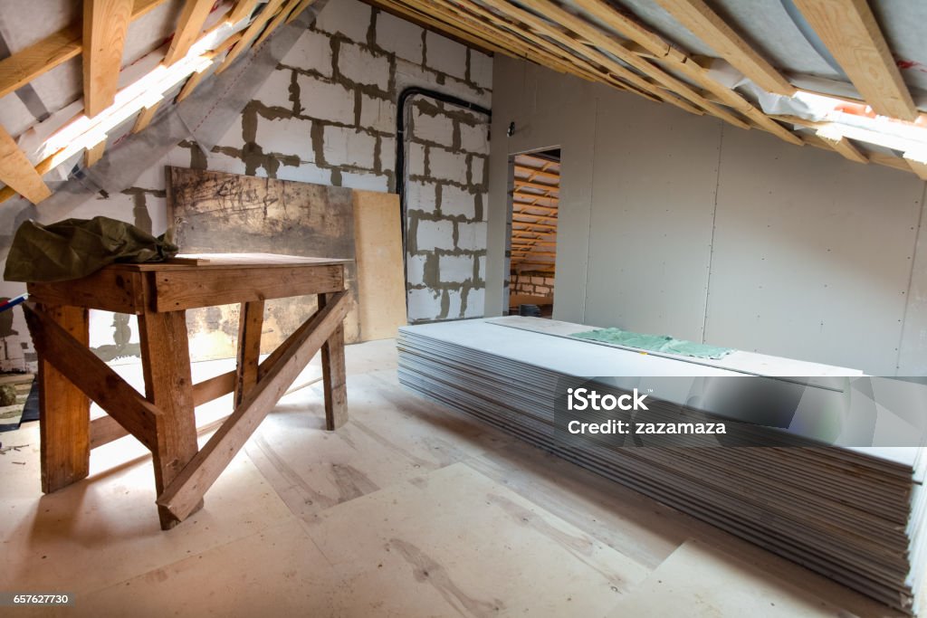 Interior of apartment with materials during under renovation, remodeling and construction. (preparing to build walls from gypsum plasterboard) Home Addition Stock Photo