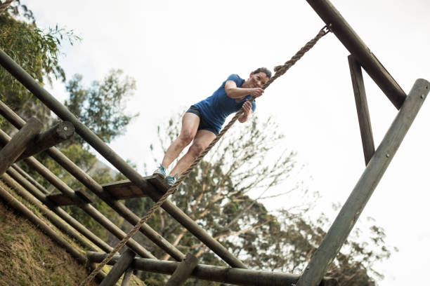 istock Fit woman holding the rope during obstacle course 657630184