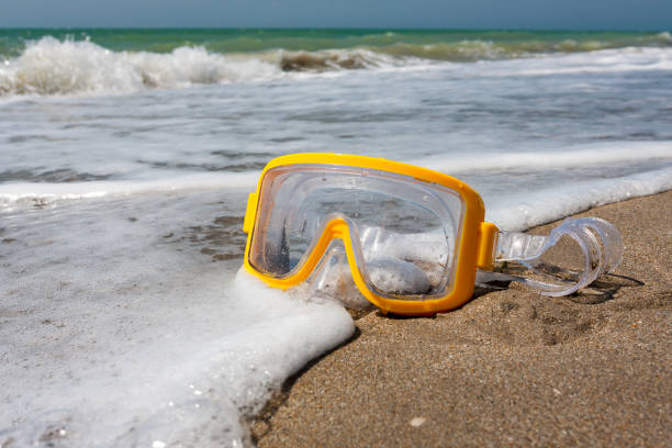 istock Swimming mask on sea beach 657640806