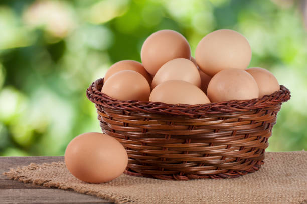 istock eggs in a wicker basket on a wooden board with blurred garden background 657656302