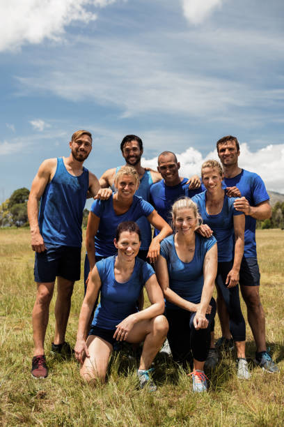 istock Group of fit people posing together in boot camp 657659306
