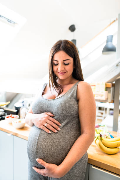 istock pregnant woman in the kitchen 657659422
