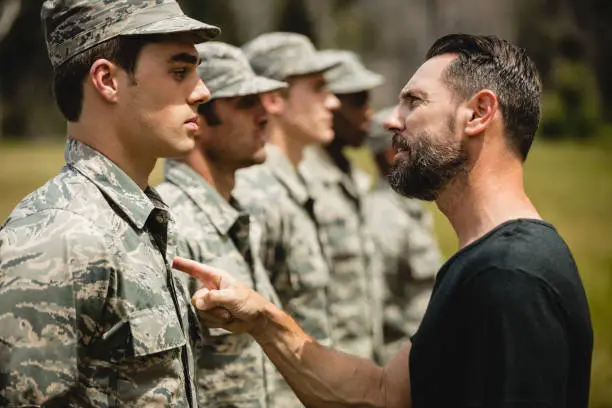 Photo of Trainer giving training to military soldier