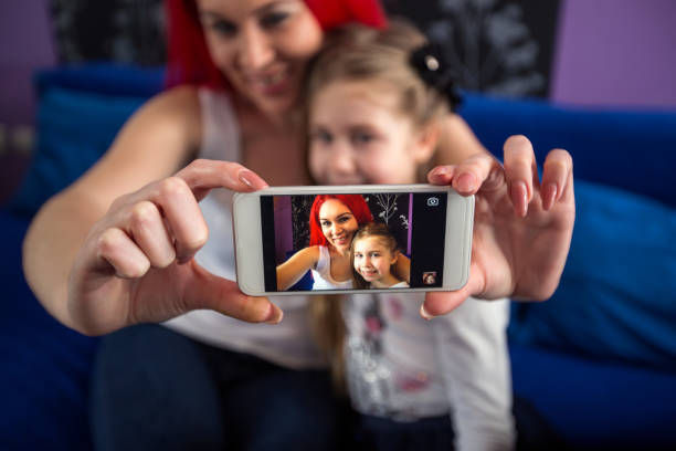 istock Taking photo with mobile phone mom and daughter 657662214