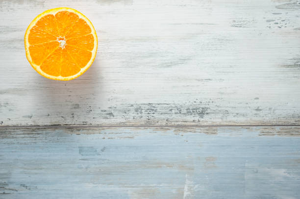 istock One slice of fresh oranges on painted wooden board 657662318