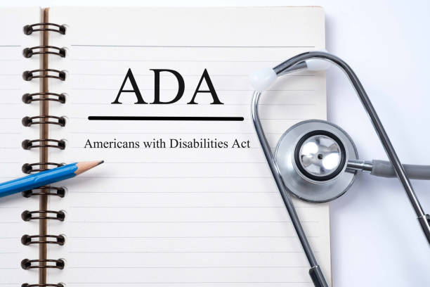 istock Stethoscope on notebook and pencil with ADA (Americans with Disabilities Act) words as medical concept. 657663156