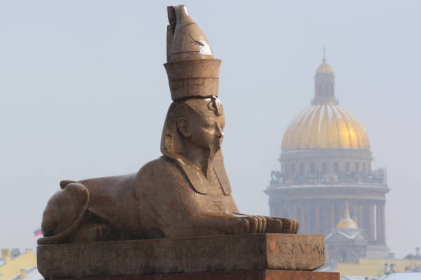 Sculpture of the sphinx on the Egyptian bridge over the Fontanka River in St. Petersburg and the clouds in the rays of the setting sun