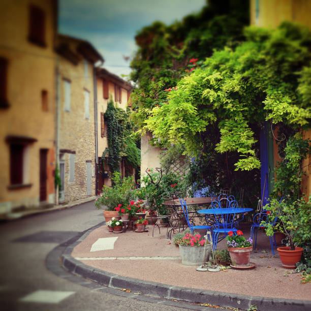 Beautiful street in Villes-sur-Auzon, Provence, France. Filtered image, old lens effect applied