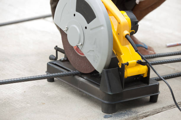 istock Construction builder worker with grinder machine cutting metal reinforcement rebar rods at building site and unsafe 657666412