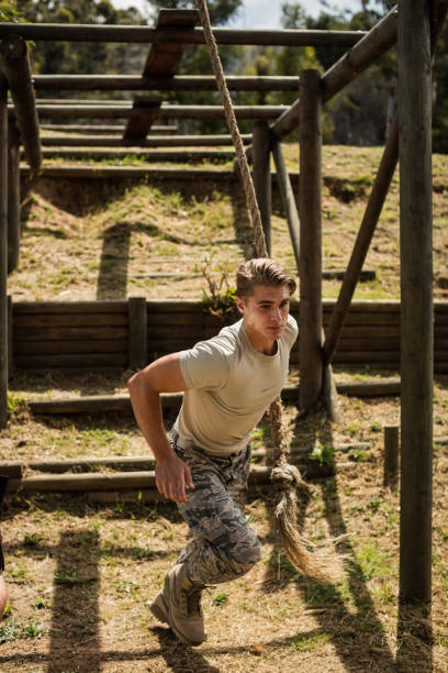 istock Military soldier training rope climbing 657670030