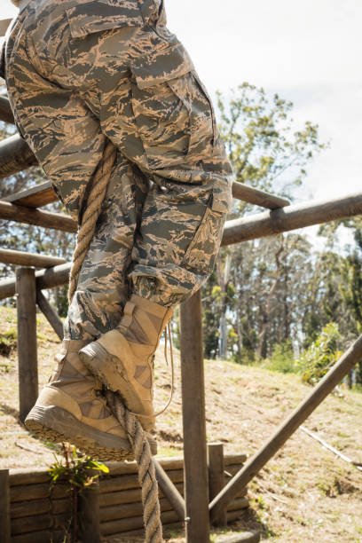 istock Military soldier training rope climbing 657672124