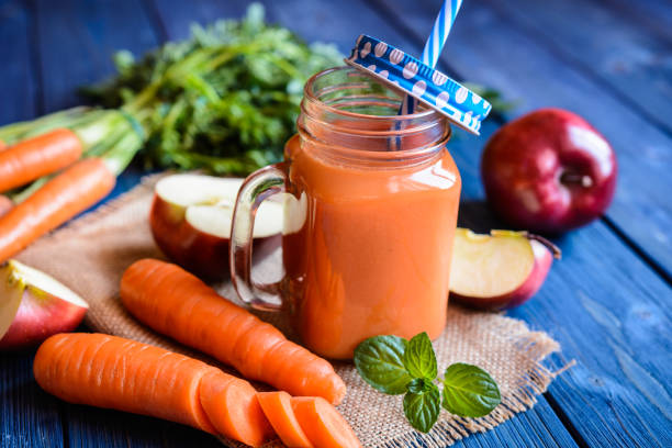 Fresh carrot and apple smoothie Fresh carrot and apple smoothie in a glass jar carotene stock pictures, royalty-free photos & images