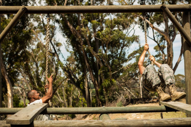 istock Military soldiers training rope climbing 657672170