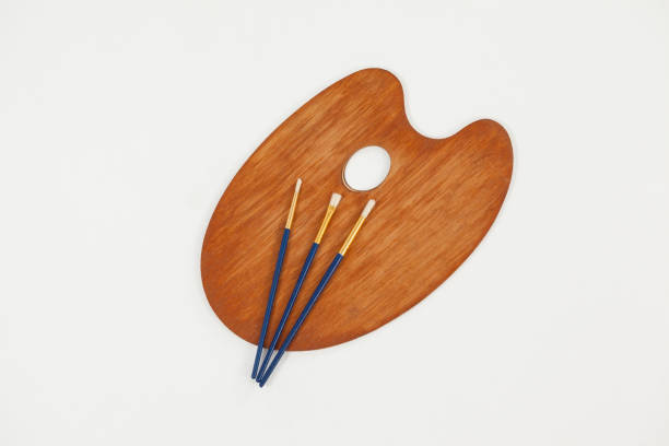istock Wooden palette and paint brushes 657672938