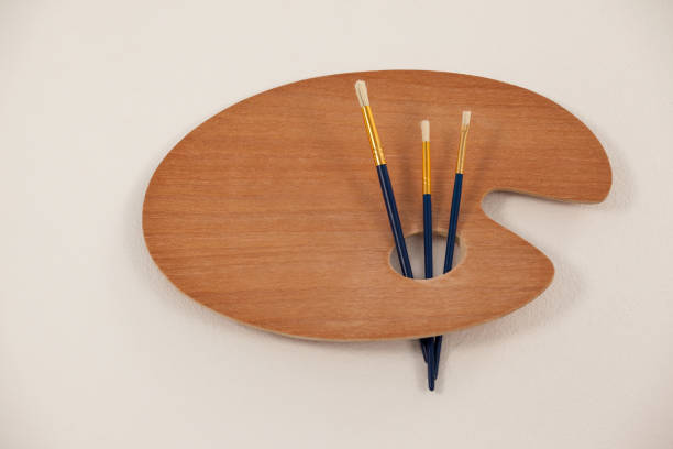 istock Wooden palette and paint brushes 657673030