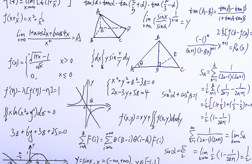 Closeup shot of complex math formulas on whiteboard.