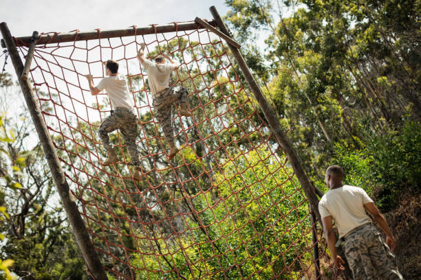 istock Military soldiers climbing rope during obstacle course 657678868