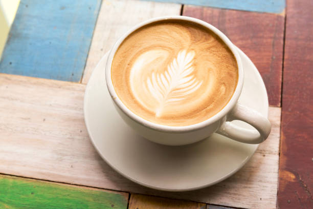 istock Cup of coffee with latte art on wooden table 657678978