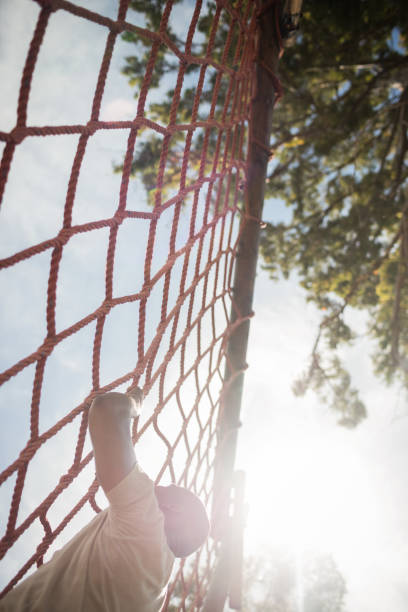 istock Military soldier climbing rope during obstacle course 657679014