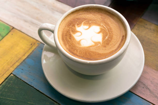 istock Cup of coffee with latte art on wooden table 657679062