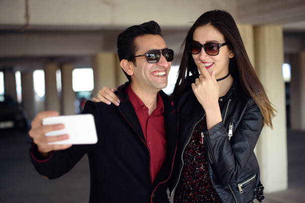 istock Young happy couple taking a selfie with smartphone 657681798