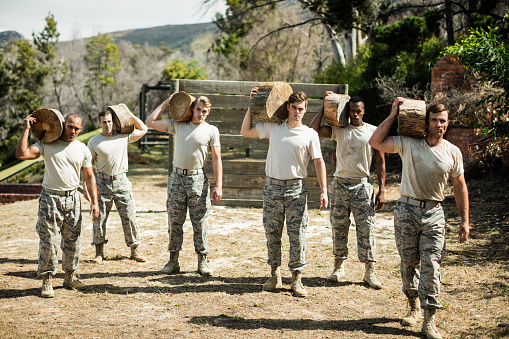 Soldiers carrying a tree log in boot camp