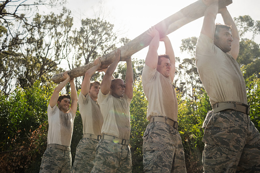 Soldiers carrying a tree log in boot camp