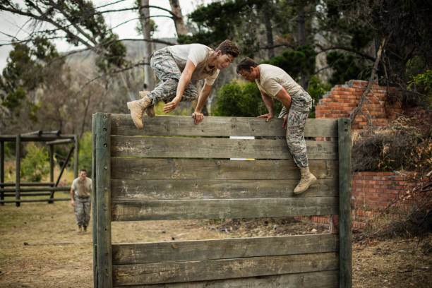 istock Soldiers climbing wooden wall 657688356