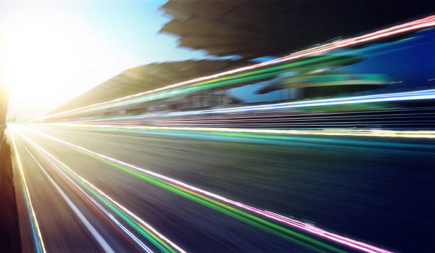 istock Foward motion speed lens blur racing circuit background with seated stand , sunset scene and light trail effect . 657688490