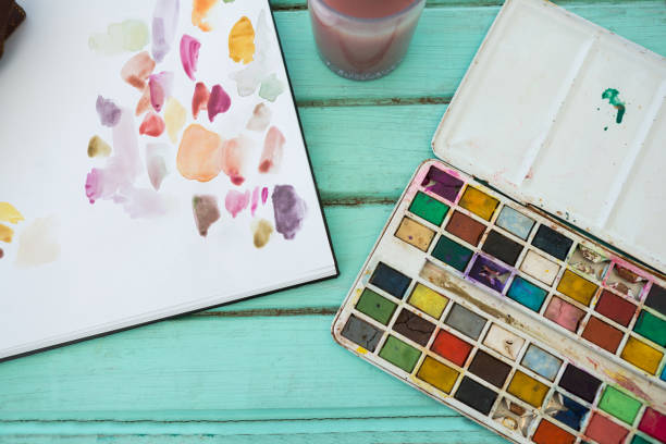 istock Colorful palette and paper on wooden surface 657688686