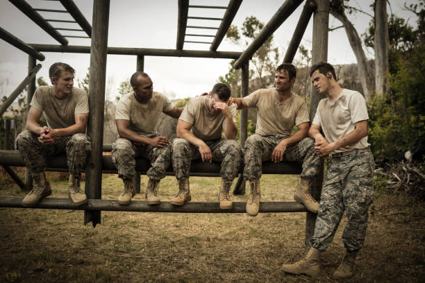 istock Soldiers comforting man 657688972