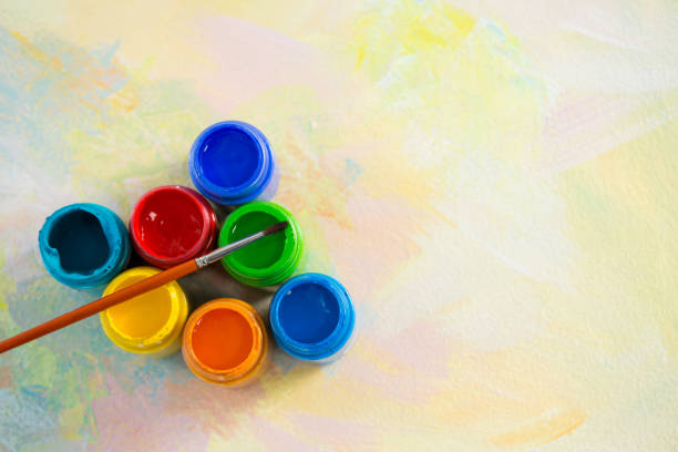 istock Paintbrush and watercolors arranged on paper 657689316