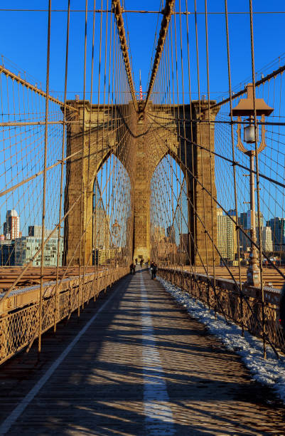 istock Stars and stripes flying on Brooklyn Bridge 657695638