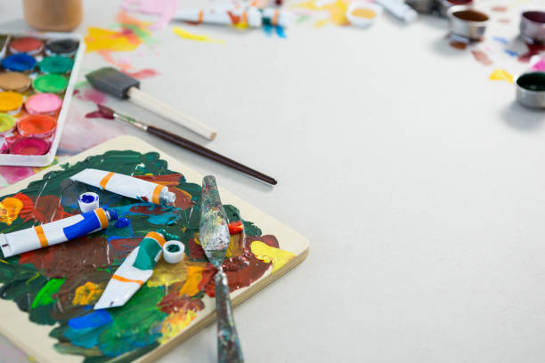istock Watercolor tubes and palette knife on white background 657697946
