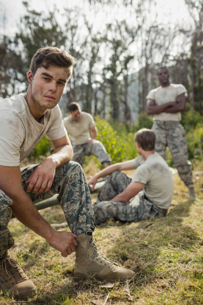 istock Soldier tying his shoe laces in boot camp 657701812