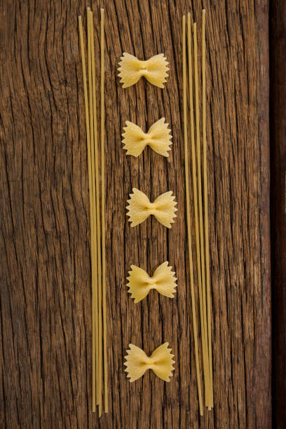 istock Farfalle and spaghetti on wooden surface 657705060