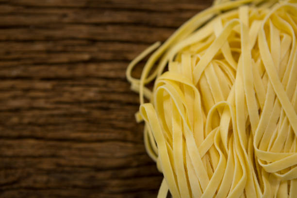 istock Raw tagliatelle pasta on wooden surface 657705150