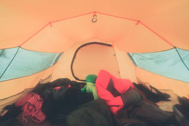 istock A process of camping in winter forest, setting a tent covered in snow, making a bonfire campfire and cooking food with portable gas cooker and fire, snowy landscape 657708002