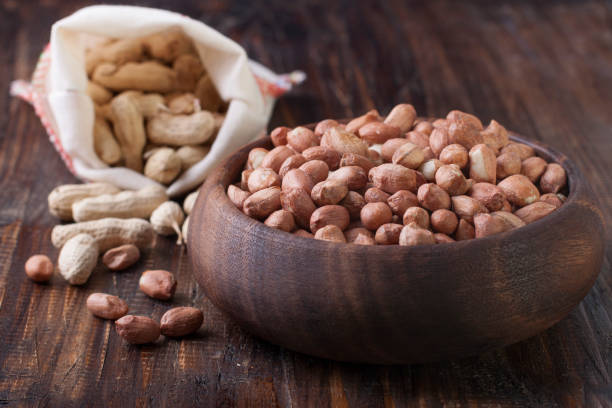 istock Peanuts in a wooden bowl on a wooden table 657724150