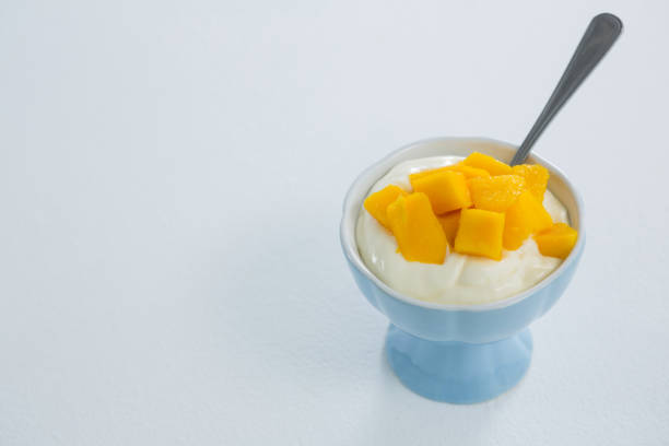 istock Chopped mangoes with cream in bowl 657727358