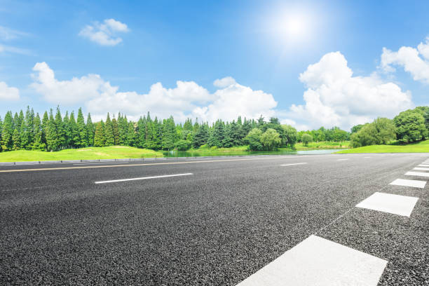 istock Asphalt road and green trees in the blue sky 657730586