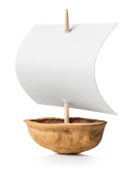 Sailboat made of walnut on white background.