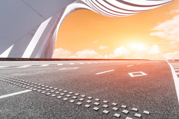 istock Asphalt road and modern building at sunset 657733450